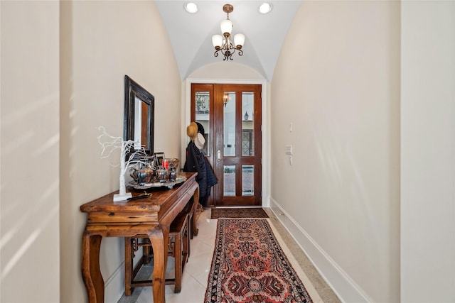 foyer featuring lofted ceiling, recessed lighting, an inviting chandelier, light tile patterned flooring, and baseboards