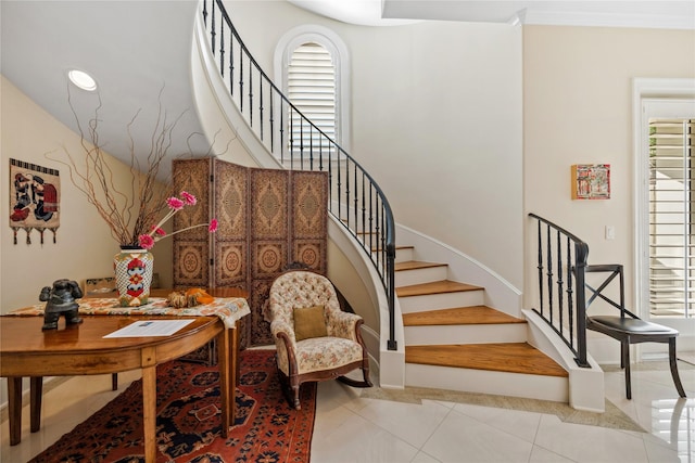 stairs with tile patterned flooring and a wealth of natural light