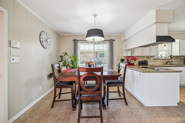 dining room featuring crown molding, light tile patterned floors, and a wealth of natural light