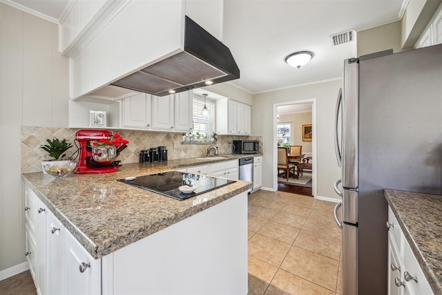 kitchen featuring visible vents, stainless steel appliances, extractor fan, and ornamental molding