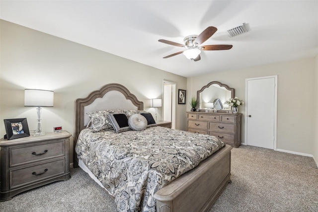 bedroom with visible vents, light colored carpet, baseboards, and ceiling fan