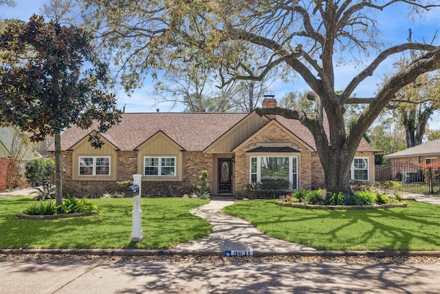 ranch-style house with brick siding, a chimney, a shingled roof, a front lawn, and board and batten siding