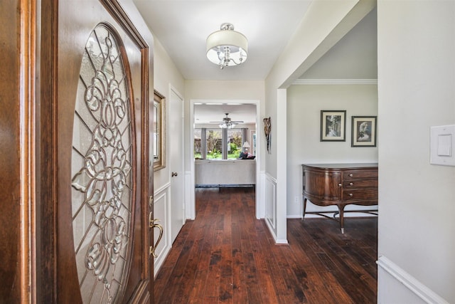 foyer entrance featuring baseboards, a notable chandelier, and hardwood / wood-style flooring