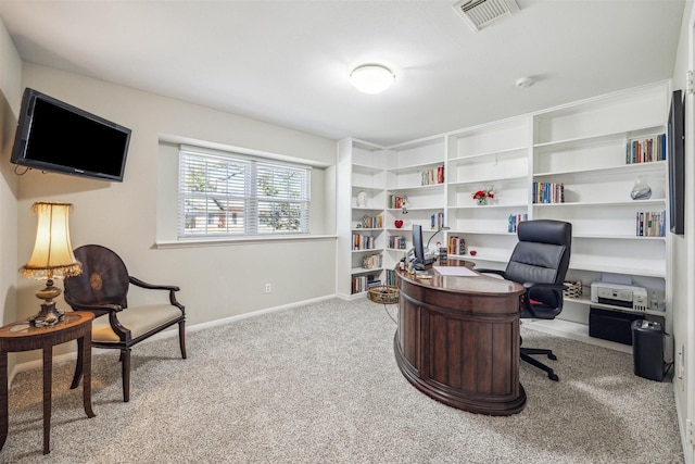 carpeted office space featuring visible vents and baseboards