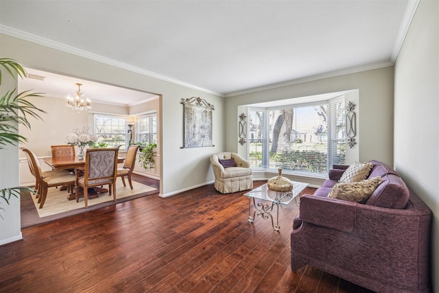 living area with an inviting chandelier, crown molding, dark wood-type flooring, and baseboards