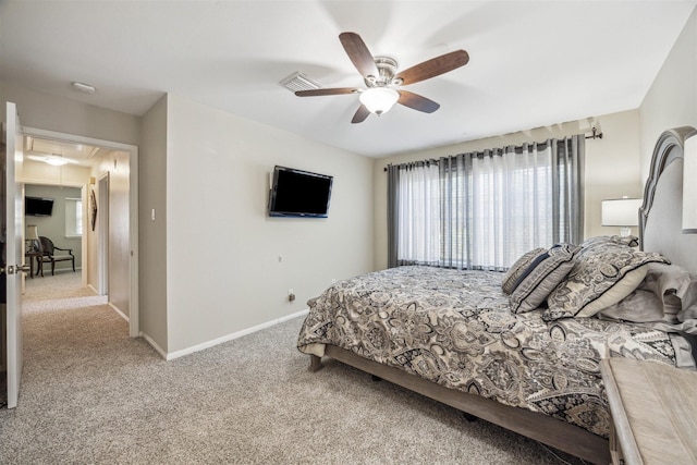 bedroom with a ceiling fan, carpet, baseboards, visible vents, and attic access