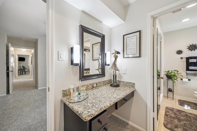 bathroom featuring tile patterned floors, toilet, vanity, and baseboards