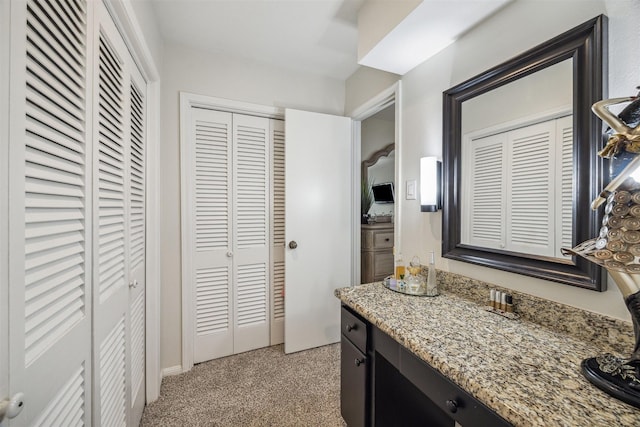 bathroom with a closet and vanity