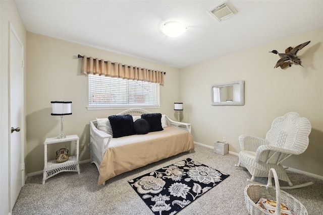 carpeted bedroom featuring baseboards and visible vents