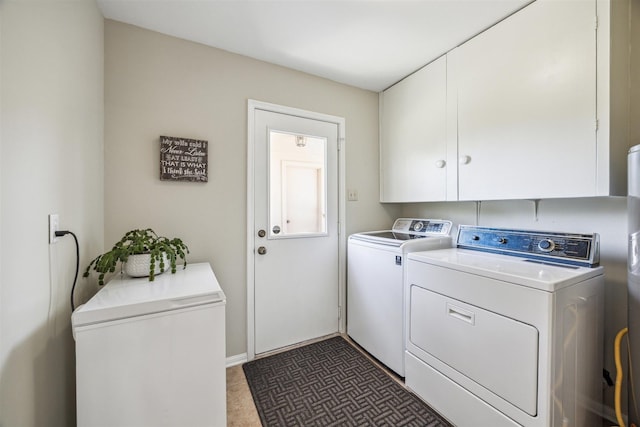 washroom with cabinet space and washer and dryer