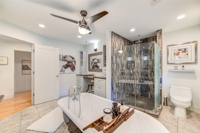 bathroom featuring recessed lighting, a soaking tub, a stall shower, and tile patterned floors