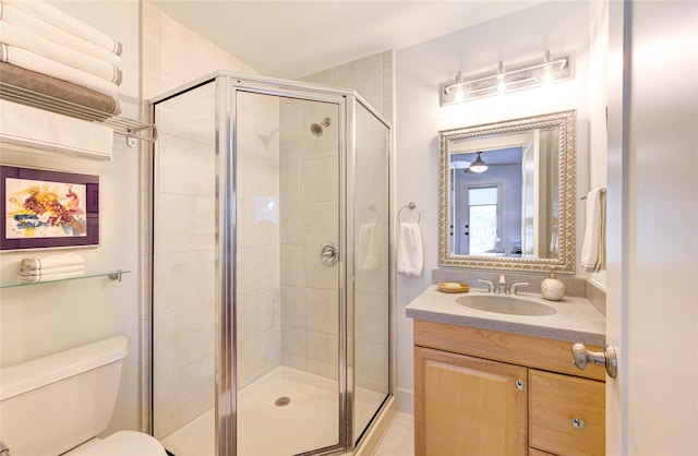 full bathroom with vanity, toilet, and a stall shower