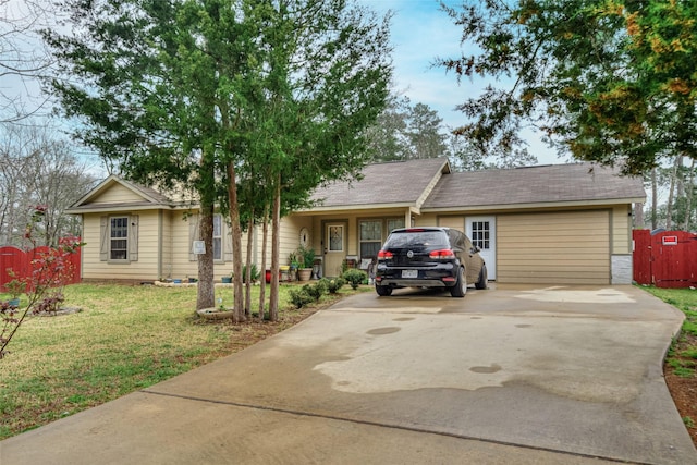 ranch-style home with driveway, a front yard, and fence