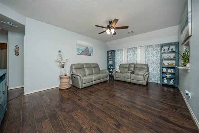 living area with hardwood / wood-style floors, a ceiling fan, visible vents, vaulted ceiling, and a textured ceiling