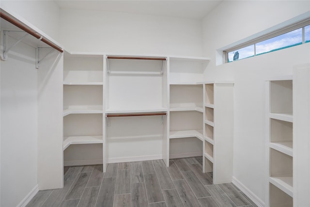 walk in closet featuring wood tiled floor