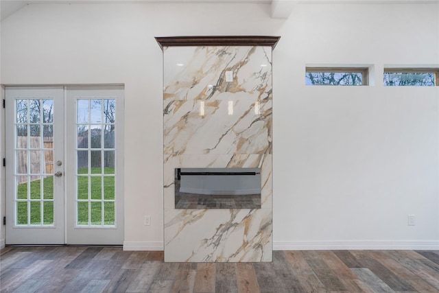 details with french doors, a fireplace, baseboards, and wood finished floors