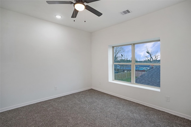 carpeted empty room with visible vents, ceiling fan, and baseboards