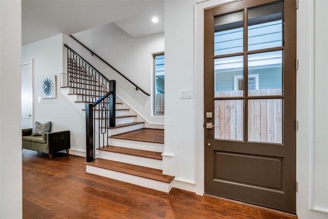 foyer entrance featuring stairway and wood finished floors