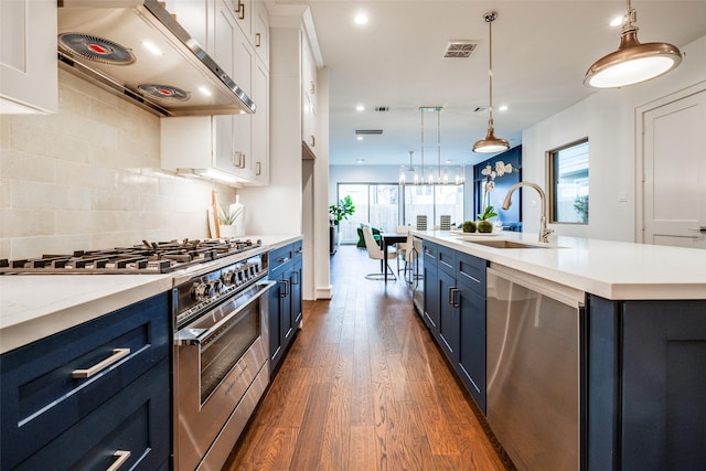 kitchen with blue cabinetry, a sink, stainless steel appliances, extractor fan, and white cabinets