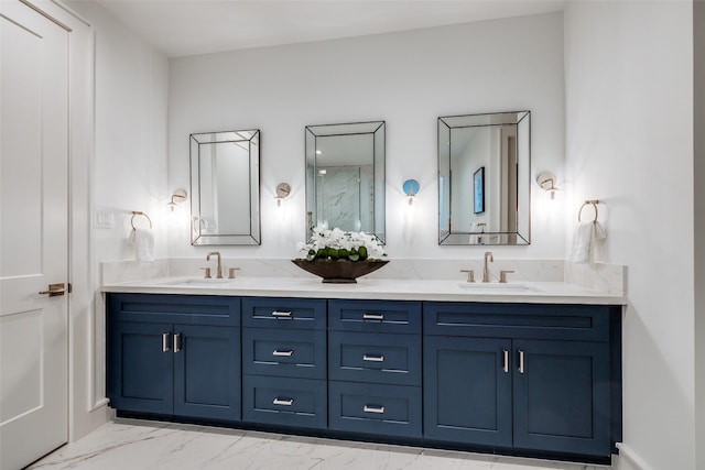 bathroom featuring double vanity, marble finish floor, and a sink