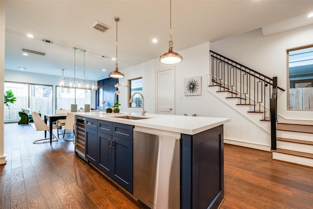 kitchen featuring dark wood-style floors, visible vents, stainless steel dishwasher, and a sink