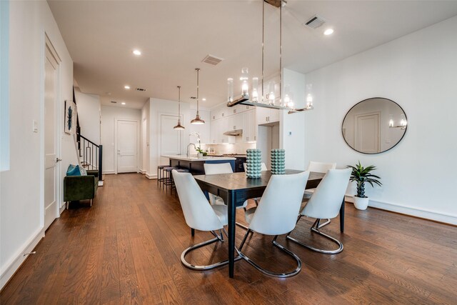 dining space with dark wood-style floors, visible vents, recessed lighting, and stairway