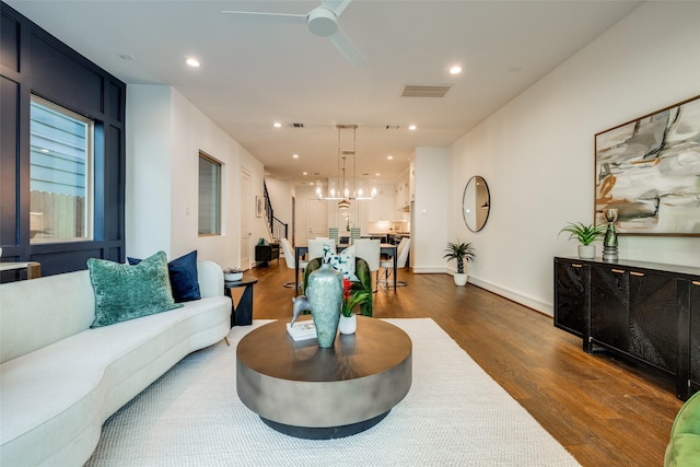 living area with dark wood-style floors, visible vents, recessed lighting, and a ceiling fan