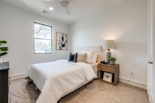 bedroom with visible vents, baseboards, and light colored carpet