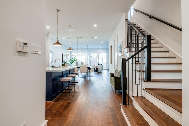 interior space featuring stairs, recessed lighting, and dark wood-style floors