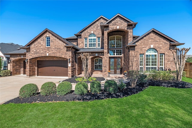 view of front of house with a front lawn, fence, brick siding, and driveway