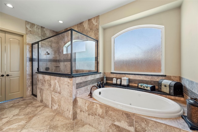 bathroom featuring recessed lighting, a stall shower, and a bath