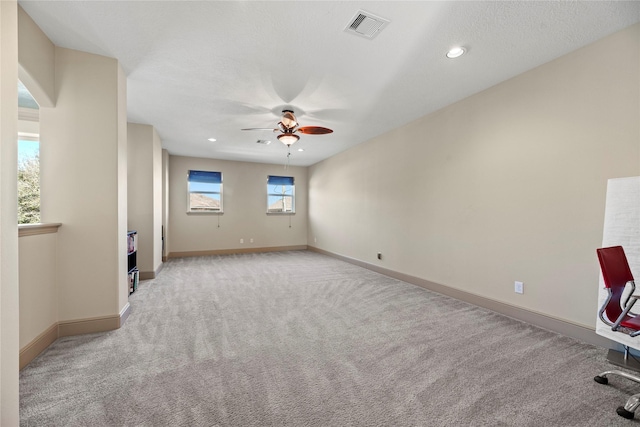 unfurnished room with visible vents, a ceiling fan, recessed lighting, baseboards, and light colored carpet