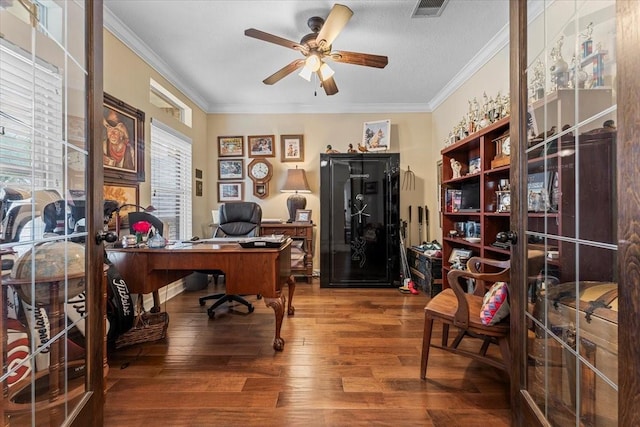 office space with visible vents, crown molding, ceiling fan, and wood finished floors