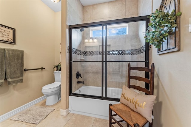 bathroom featuring tile patterned flooring, toilet, baseboards, and bath / shower combo with glass door