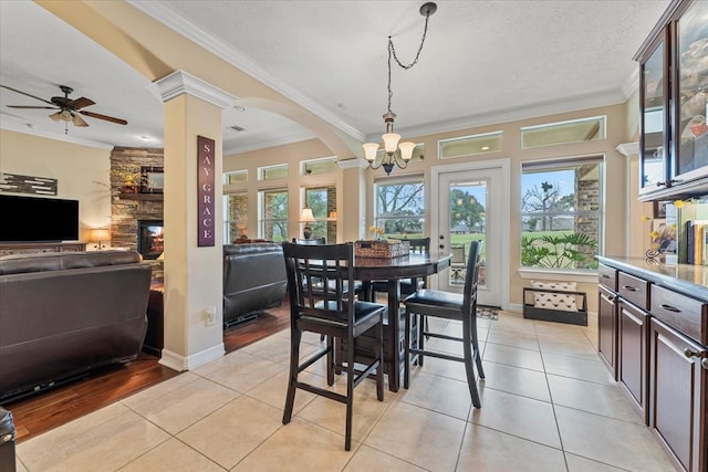 dining space featuring crown molding, light tile patterned floors, and baseboards