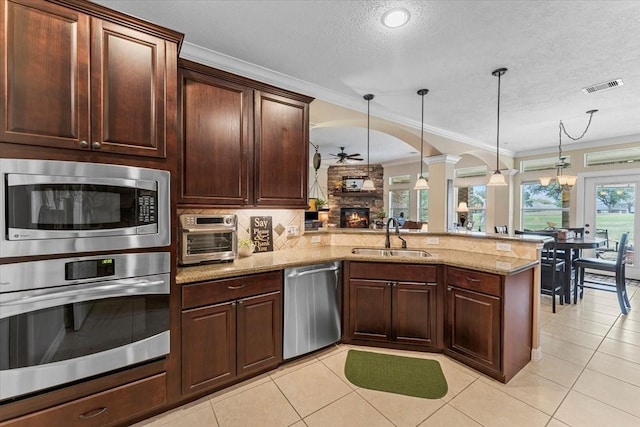 kitchen featuring tasteful backsplash, visible vents, appliances with stainless steel finishes, a ceiling fan, and a sink