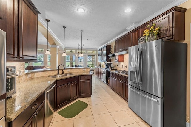 kitchen with a sink, ornamental molding, light tile patterned floors, and stainless steel appliances