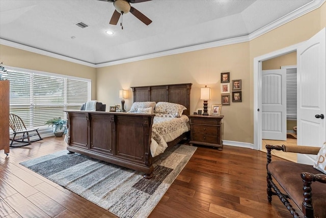 bedroom with dark wood-style floors, visible vents, baseboards, ceiling fan, and crown molding