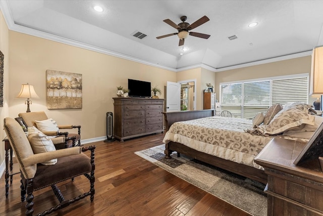 bedroom featuring crown molding, visible vents, and a raised ceiling