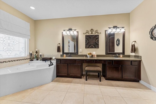 full bathroom with tile patterned floors, a bath, and a sink