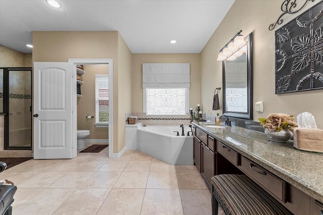 full bathroom with tile patterned floors, a garden tub, toilet, a stall shower, and vanity