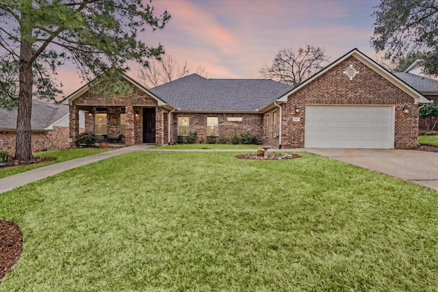 ranch-style house featuring brick siding, an attached garage, concrete driveway, and a front lawn