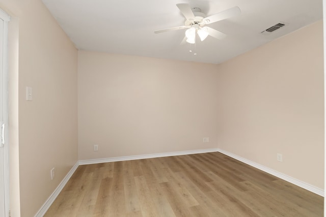 spare room with visible vents, baseboards, light wood-style floors, and ceiling fan