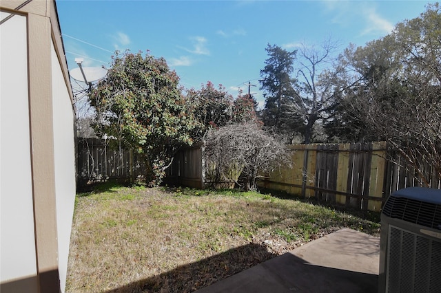 view of yard with a patio area, central air condition unit, and a fenced backyard