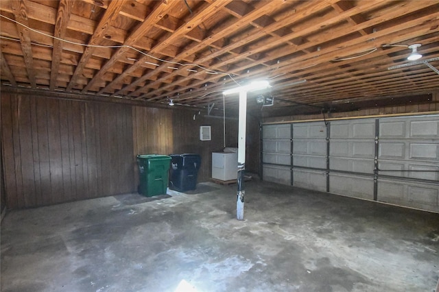 garage with washer / dryer and wooden walls