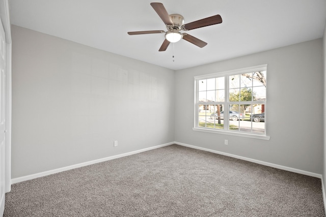 unfurnished room featuring carpet, baseboards, and ceiling fan