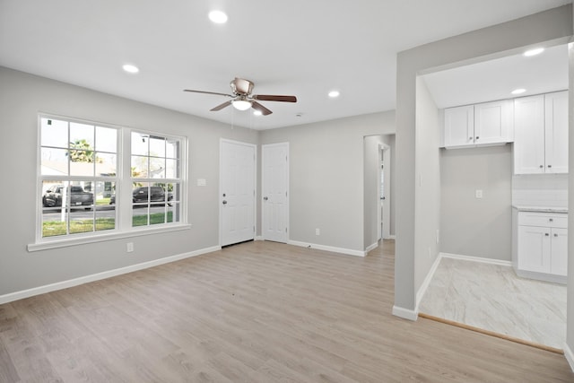 unfurnished living room featuring recessed lighting, baseboards, light wood-style floors, and a ceiling fan