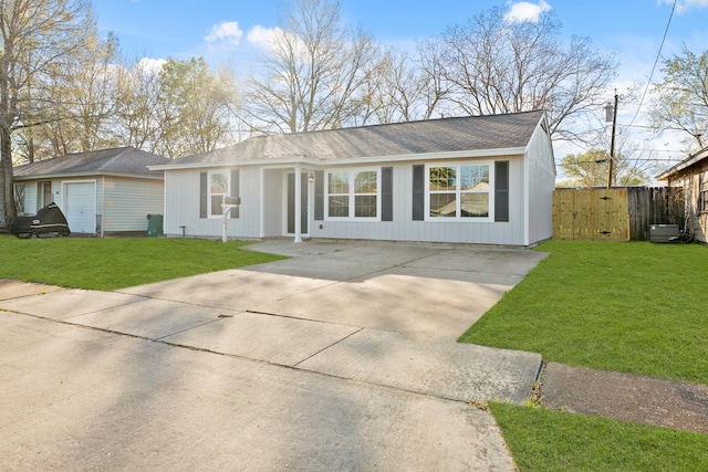 ranch-style house with a front lawn, concrete driveway, and fence