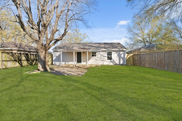 back of property featuring a yard and a fenced backyard