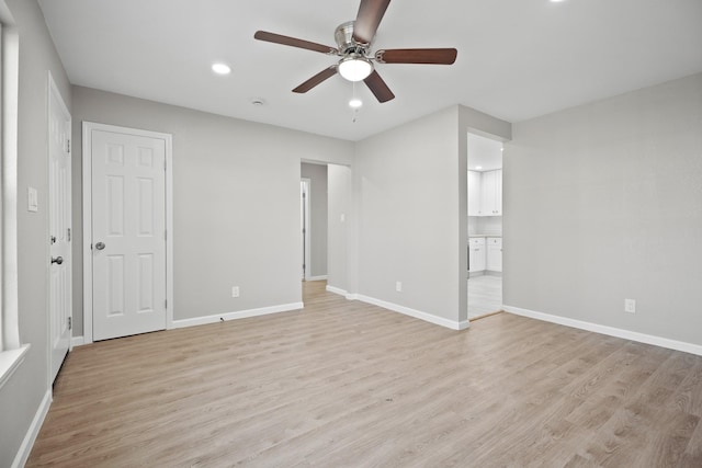 unfurnished bedroom featuring baseboards, ensuite bath, recessed lighting, ceiling fan, and light wood-type flooring